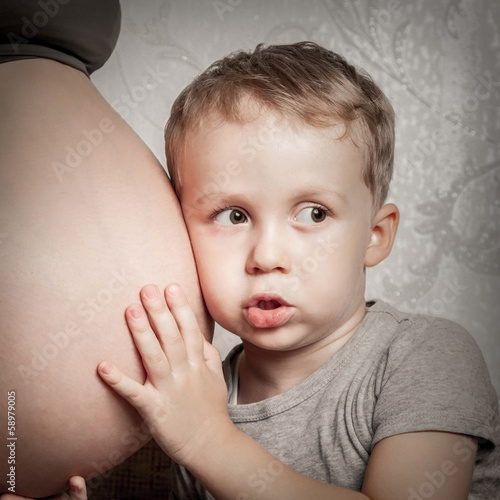 Photo: Boy hugging pregnant moms belly Boy hugging pregnant moms belly