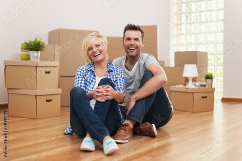 Photo: Portrait of laughing couple in new home Portrait of laughing couple in new home