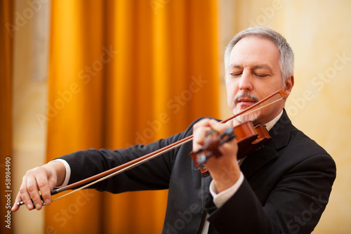 Photo: Man playing a violin Man playing a violin
