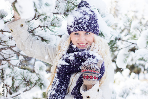 Photo: beautiful winter woman playing with snow beautiful winter woman playing with snow