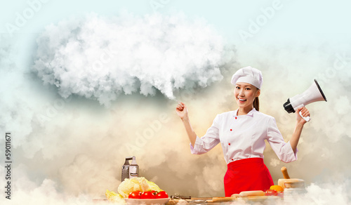 Photo: Asian female cook holding megaphone Asian female cook holding megaphone