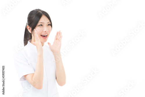 Photo: young asian nurse yelling on white background young asian nurse yelling on white background