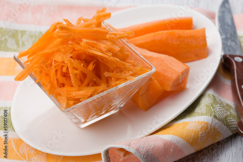 Photo: Grated carrots on board Grated carrots on board