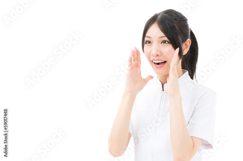 Photo: young asian nurse yelling on white background young asian nurse yelling on white background