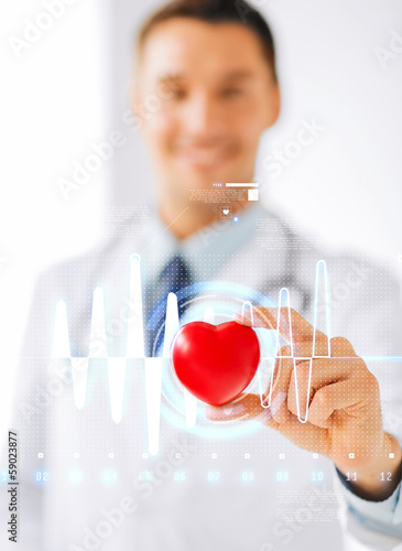 Photo: male doctor with heart and cardiogram male doctor with heart and cardiogram