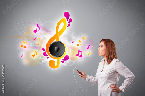 Photo: pretty girl singing and listening to music with musical notes pretty girl singing and listening to music with musical notes