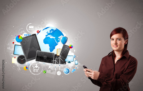 Photo: young woman standing and browsing on her phone young woman standing and browsing on her phone