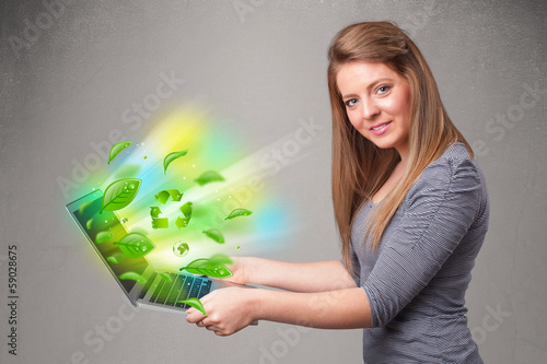 Photo: Casual woman holding notebook with recycle and environmental sym Casual woman holding notebook with recycle and environmental sym