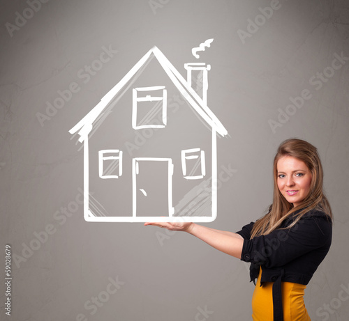 Photo: Young lady holding a huge drawn house Young lady holding a huge drawn house