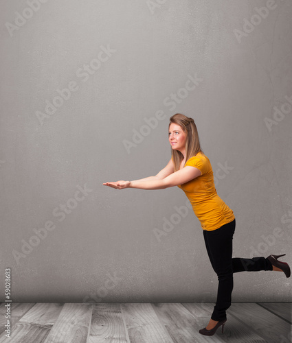 Photo: Pretty woman presenting an empty copy space Pretty woman presenting an empty copy space