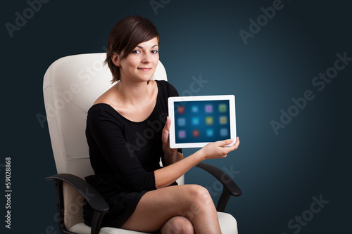 Photo: woman holding modern tablet with colorful icons woman holding modern tablet with colorful icons