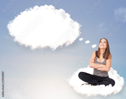 Photo: Young girl sitting on cloud and thinking of abstract speech bubb Young girl sitting on cloud and thinking of abstract speech bubb