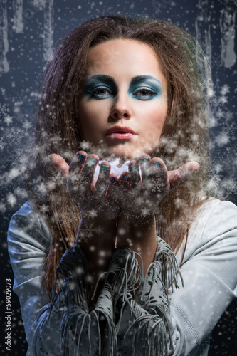 Photo: Girl blowing snowflakes Girl blowing snowflakes
