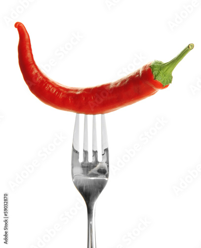 Photo: Red hot chili pepper on fork, isolated on white Red hot chili pepper on fork, isolated on white