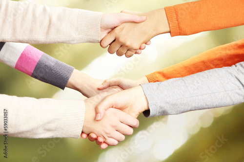 Photo: Handshakes on bright background Handshakes on bright background
