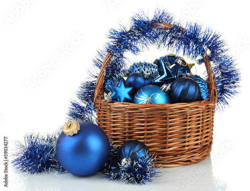 Photo: Christmas decorations in basket isolated on white Christmas decorations in basket isolated on white