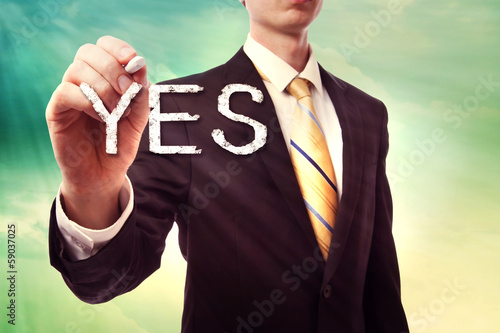 Photo: Businessman drawing YES Businessman drawing YES