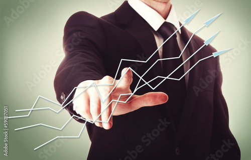 Photo: Businessman pointing arrows Businessman pointing arrows