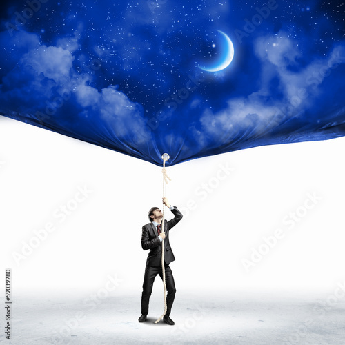 Photo: Businessman pulling banner Businessman pulling banner