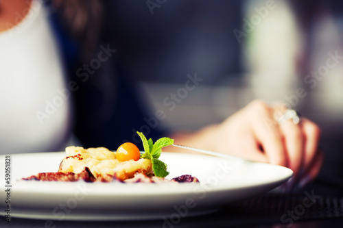 Photo: Female hand with a dinner at restaurant Female hand with a dinner at restaurant