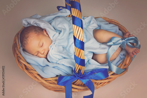 Photo: Sleeping newborn in basket Sleeping newborn in basket