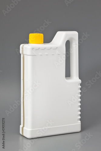 Photo: White detergent plastic bottle isolated on gray White detergent plastic bottle isolated on gray