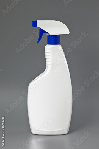 Photo: White detergent plastic spray bottle Isolated on gray White detergent plastic spray bottle Isolated on gray