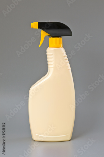 Photo: Beige detergent plastic spray bottle Isolated on gray Beige detergent plastic spray bottle Isolated on gray