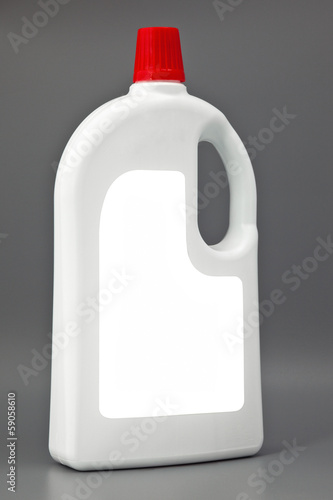 Photo: White detergent plastic bottle isolated on gray White detergent plastic bottle isolated on gray