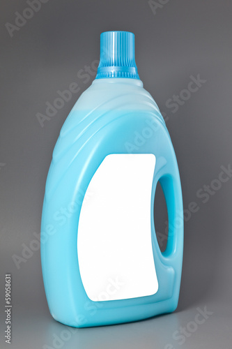 Photo: Transparent detergent plastic bottle isolated on gray Transparent detergent plastic bottle isolated on gray