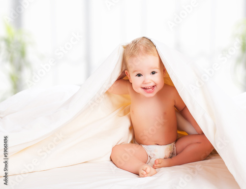 Photo: happy baby under a blanket laughing happy baby under a blanket laughing