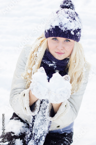 Photo: beautiful winter woman playing with snow beautiful winter woman playing with snow