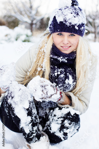 Photo: beautiful winter woman playing with snow beautiful winter woman playing with snow