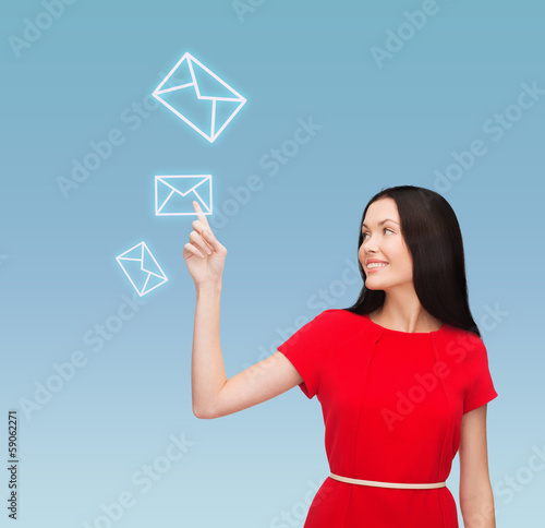 Photo: young woman in red dress pointing her finger young woman in red dress pointing her finger
