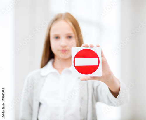 Photo: girl showing no entry sign girl showing no entry sign