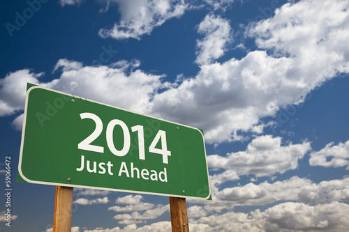 Photo: 2014 Just Ahead Green Road Sign Over Clouds and Sky 2014 Just Ahead Green Road Sign Over Clouds and Sky