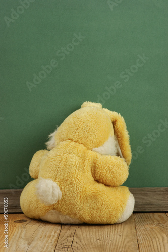 Photo: Old toy bunny on a wooden floor Old toy bunny on a wooden floor