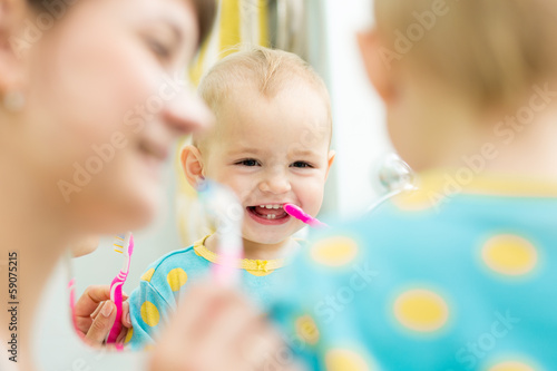 Photo: mother teaches baby brushing teeth mother teaches baby brushing teeth
