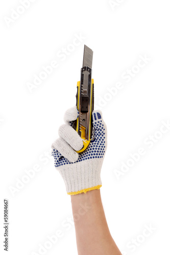 Photo: Hand in gloves holds office knife. Hand in gloves holds office knife.