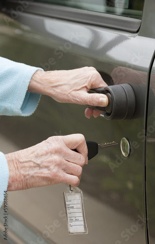 Photo: Using a key to unlock car door Using a key to unlock car door