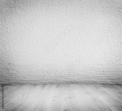 Photo: White minimalist plaster, concrete wall background. Wooden floor White minimalist plaster, concrete wall background. Wooden floor