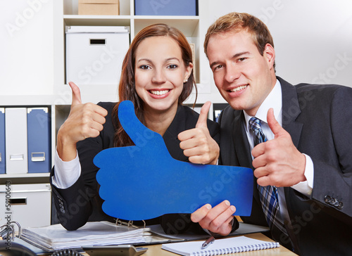 Photo: Business people holding many thumbs up Business people holding many thumbs up