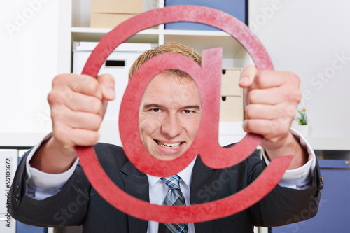 Photo: Business man looking through internet sign Business man looking through internet sign