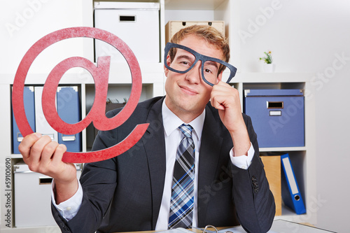 Photo: Business man with internet sign and nerd glasses Business man with internet sign and nerd glasses