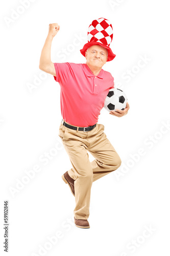 Photo: Middle aged sport holding a ball gesturing happiness Middle aged sport holding a ball gesturing happiness