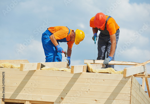Photo: carpenters at wooden roof work carpenters at wooden roof work