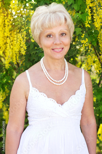 Photo: Beautiful adult woman with flowers Beautiful adult woman with flowers