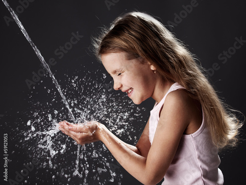Photo: Stream of clean water pouring into children's hands Stream of clean water pouring into children's hands
