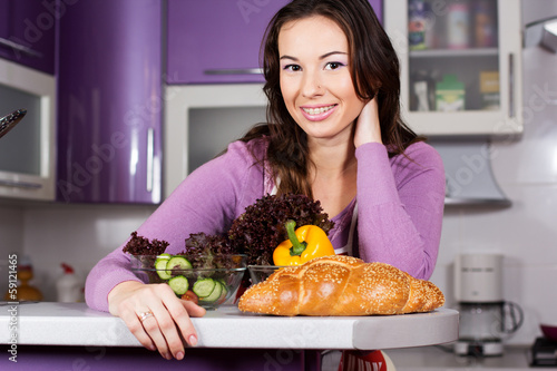 Photo: Pretty woman cooking food in the kitchen Pretty woman cooking food in the kitchen
