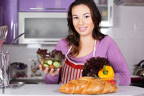 Photo: Pretty woman cooking food in the kitchen Pretty woman cooking food in the kitchen